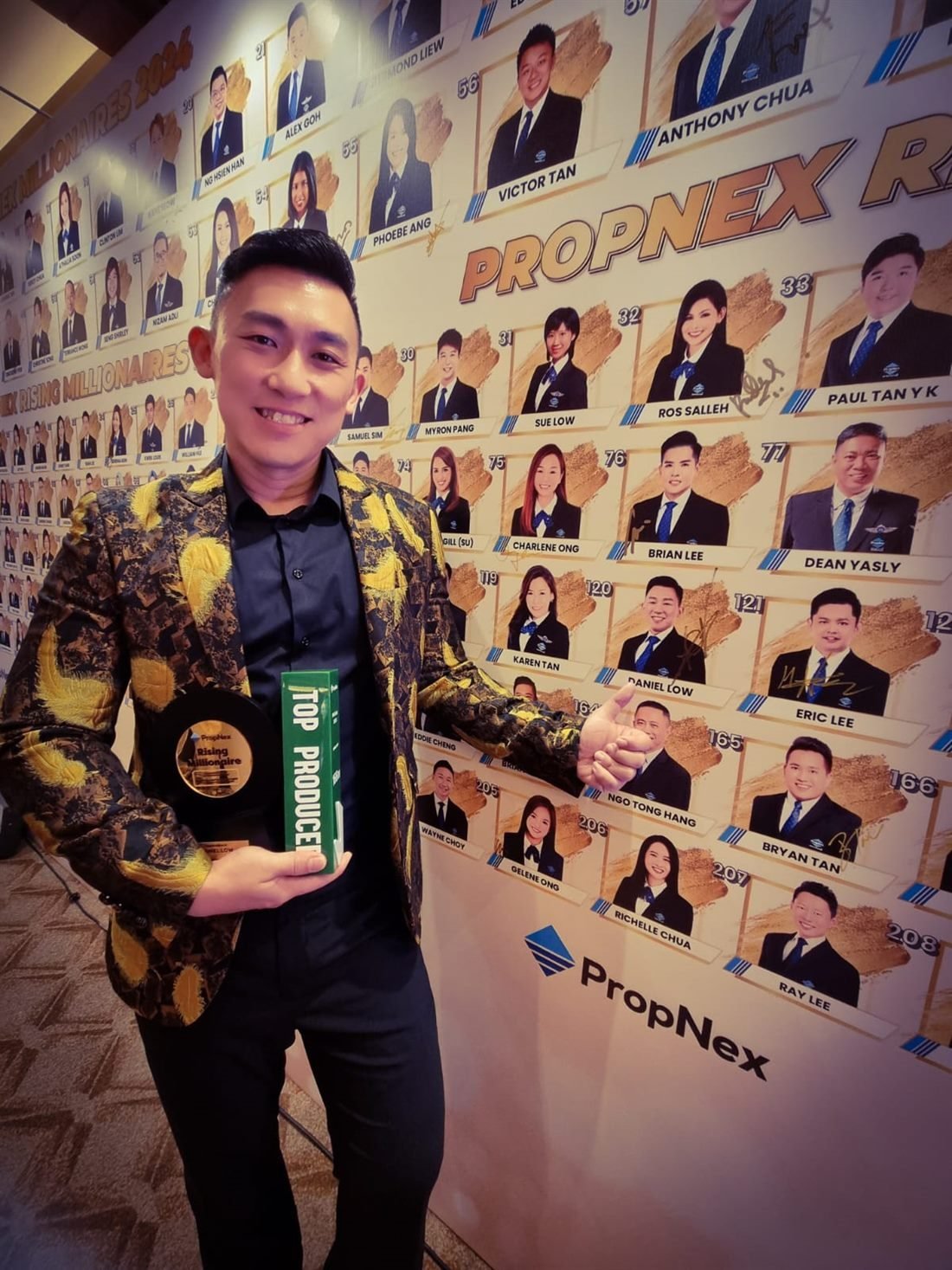 Daniel Low receiving a Top Producer / Rising Millionaire award at PropNex